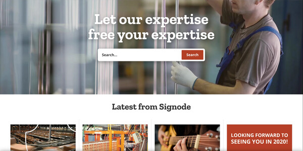 Signode homepage, as archived by the Wayback Machine in December 2019: a warehouse worker behind the headline “Let our expertise free your expertise” and a search bar, with a row of “Latest from Signode” news cards below.